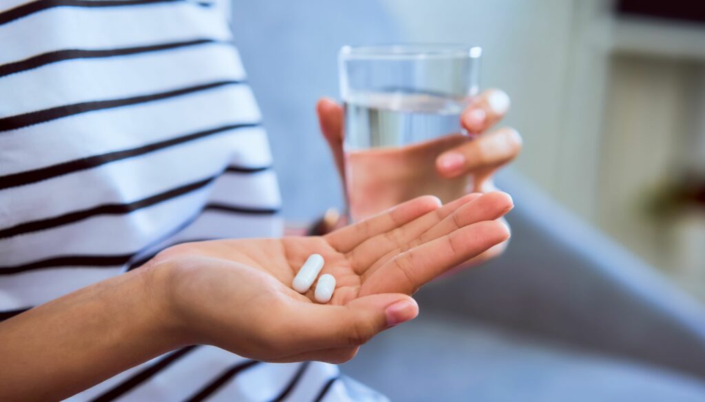 woman with medicine and water