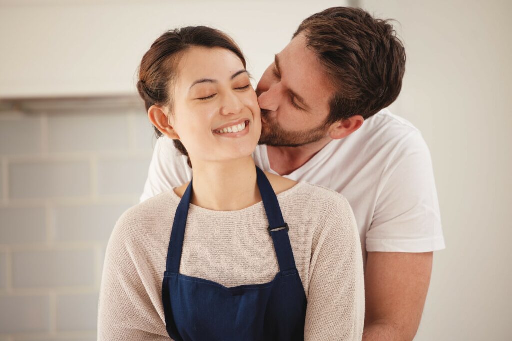 man kissing partner on the cheek